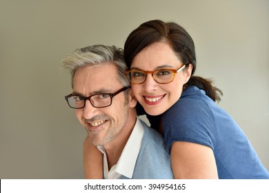 Middle-aged Couple With Eyeglasses On Beige Background