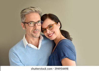 Middle-aged Couple With Eyeglasses On Beige Background