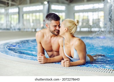 A middle-aged couple in love in swimwear is relaxing and flirting at the pool with thermal water. Moments to remember in spa center. Couple in the pool with thermal water. - Powered by Shutterstock