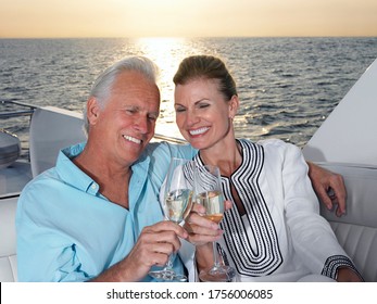 Middle-aged couple toasting with champagne - Powered by Shutterstock