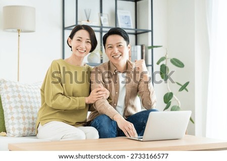 A middle-aged couple using a computer