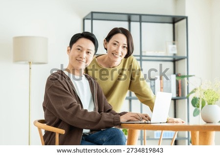 A middle-aged couple using a computer