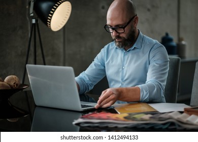 Middle-aged designer working in office - Shutterstock ID 1412494133