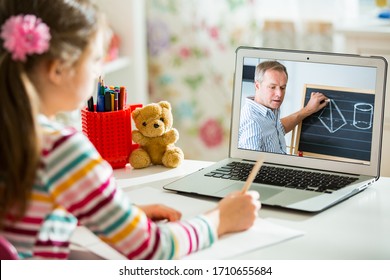 Middle-aged Distance Teacher Having Video Conference Call With Pupil Using Webcam. Online Education And E-learning Concept. Home Quarantine Distance Learning And Working From Home.