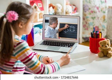 Middle-aged distance teacher having video conference call with pupil using webcam. Online education and e-learning concept. Home quarantine distance learning and working from home.