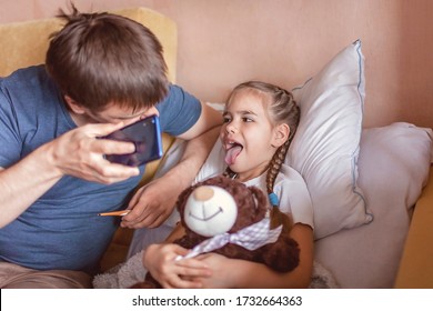 Middle-aged father looking at screen of smartphone and consulting with a doctor online at home, telehealth services during lockdown, distant video call, modern tech healthcare application - Powered by Shutterstock