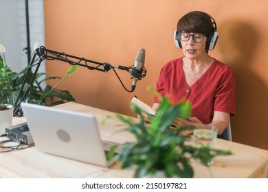 Middle-aged Female Radio Presenter Talking Into The Microphone And Reading News - Radio Broadcast Online Concept