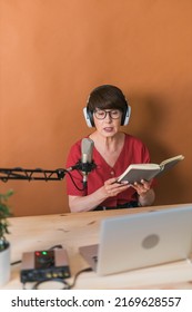 Middle-aged Female Radio Presenter Talking Into The Microphone And Reading News - Radio Broadcast Online Concept