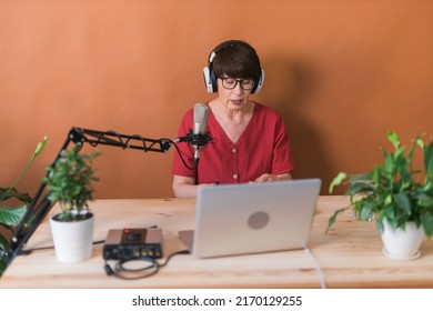 Middle-aged Female Radio Presenter Talking Into The Microphone And Reading News - Radio Broadcast Online Concept