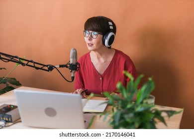 Middle-aged Female Radio Presenter Talking Into The Microphone And Reading News - Radio Broadcast Online Concept