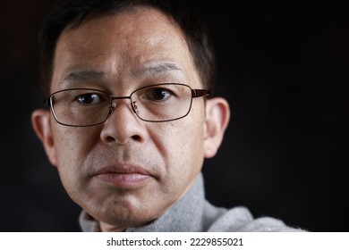 Middle-aged Japanese man in gray turtleneck wool sweater. Concept image of Warm Biz, stability in daily life, and sustainable living. - Shutterstock ID 2229855021