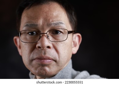 Middle-aged Japanese man in gray turtleneck wool sweater. Concept image of Warm Biz, stability in daily life, and sustainable living. - Shutterstock ID 2230055551