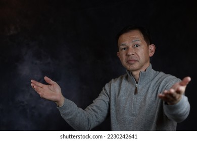 Middle-aged Japanese man in gray turtleneck wool sweater. Concept image of Warm Biz, stability in daily life, and sustainable living. - Shutterstock ID 2230242641