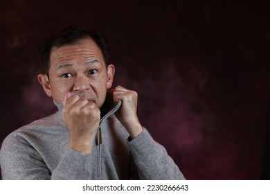 Middle-aged Japanese man in gray turtleneck wool sweater. Concept image of Warm Biz, stability in daily life, and sustainable living. - Shutterstock ID 2230266643
