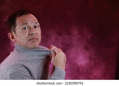 Middle-aged Japanese man in gray turtleneck wool sweater. Concept image of Warm Biz, stability in daily life, and sustainable living. - Shutterstock ID 2230398793