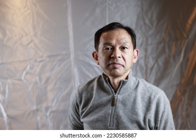Middle-aged Japanese man in gray turtleneck wool sweater. Concept image of Warm Biz, stability in daily life, and sustainable living. - Shutterstock ID 2230585887