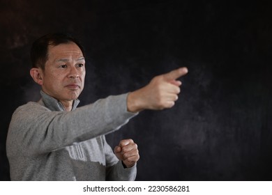 Middle-aged Japanese man in gray turtleneck wool sweater. Concept image of Warm Biz, stability in daily life, and sustainable living. - Shutterstock ID 2230586281