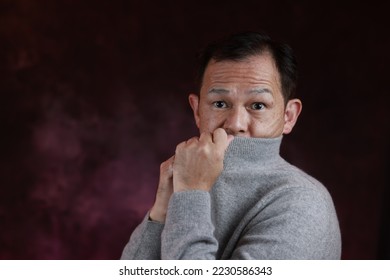 Middle-aged Japanese man in gray turtleneck wool sweater. Concept image of Warm Biz, stability in daily life, and sustainable living. - Shutterstock ID 2230586343