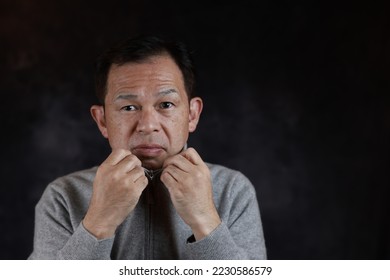 Middle-aged Japanese man in gray turtleneck wool sweater. Concept image of Warm Biz, stability in daily life, and sustainable living. - Shutterstock ID 2230586579