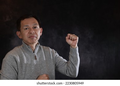 Middle-aged Japanese man in gray turtleneck wool sweater. Concept image of Warm Biz, stability in daily life, and sustainable living. - Shutterstock ID 2230805949