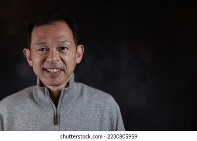 Middle-aged Japanese man in gray turtleneck wool sweater. Concept image of Warm Biz, stability in daily life, and sustainable living. - Shutterstock ID 2230805959