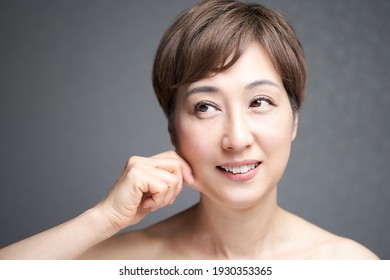 Middle-aged Japanese Woman Pulling Chin Skin