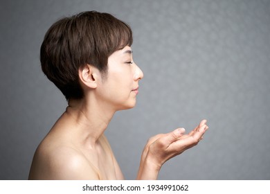 Middle-aged Japanese Woman Spreading Her Hands In Profile