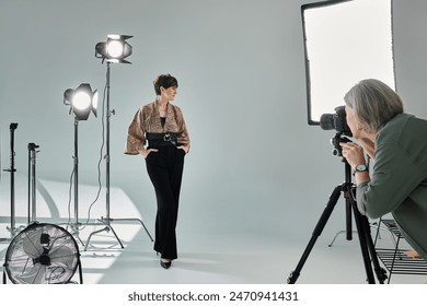 Middle-aged lesbian couple in a vibrant studio setting - one photographer with camera, the other posing as a model. - Powered by Shutterstock