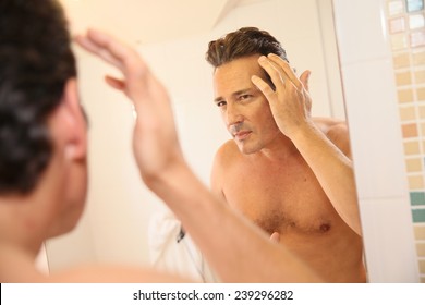 Middle-aged Man Concerned With Hair Loss