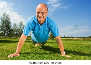 Middle-aged man doing push-ups - Powered by Shutterstock