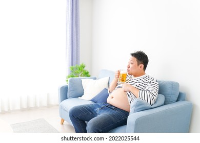 Middle-aged Man Drinking Beer At Home