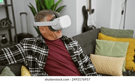 A middle-aged man with gray hair enjoys virtual reality in a cozy living room setting, evoking modern technology and leisure. - Powered by Shutterstock