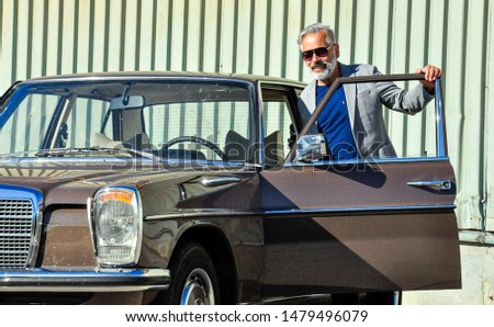 Middle-aged man with his Mercedes classic car