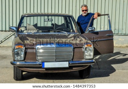 Middle-aged man with his vintage car
