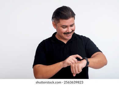 A middle-aged man interacts with his smartwatch, adjusting settings while smiling, isolated on a white backdrop. - Powered by Shutterstock