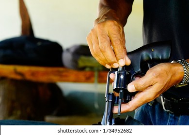 Middle-aged Man Loading A Gun                