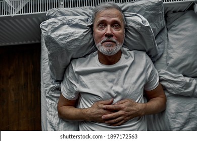 Middle-aged Man Lying Down In Bed On Pillow, Having Insomnia Sleeping Disorder. Alone At Home