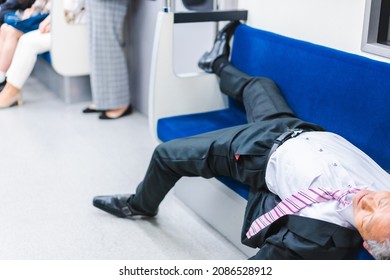 Middle-aged man lying down on a train