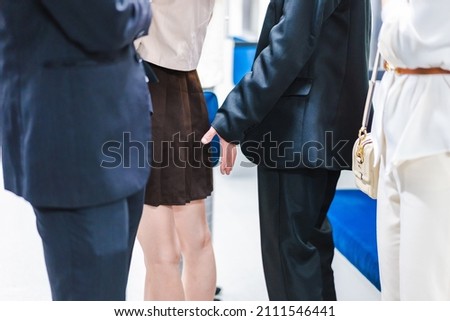 Middle-aged man molesting someone on the train