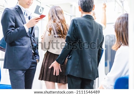 Middle-aged man molesting someone on the train