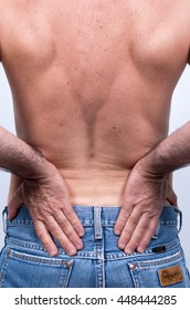 
Middle-aged Man With Pain In The Lumbar Region Pushes  To Relieve It