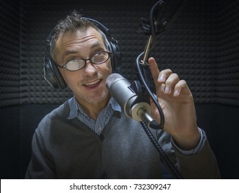 Middle-aged Man In Radio Studio Talking In Microphone