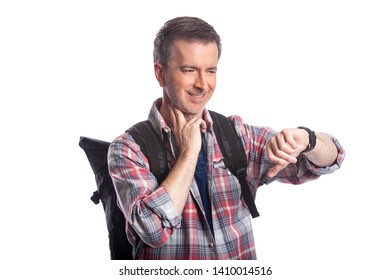 Middle-aged man or senior citizen checking heart rate pulse with health apps on a smartwatch.  He also looks like a hiker checking the wearable technology for gps navigation. - Powered by Shutterstock