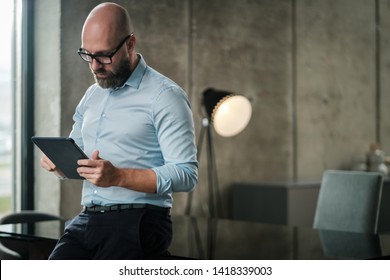 Middle-aged Man With A Tablet Pc In An Office