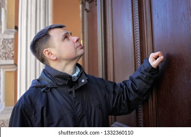 Middle-aged Man Waiting In Front Of Wooden House Door And Thinking To Knock Or Not To Knock, People Relationship, Date And Meeting Concept, Outdoor