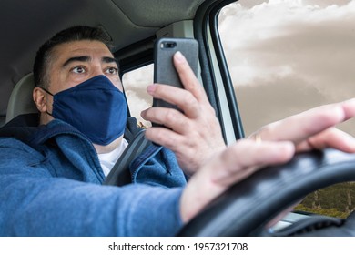 Middle-aged Man Wearing Mask, Using Cell Phone And Distracted While Driving A Car Frightened By The Accident About To Occur On The Road Concept Road Safety Telephony And Security