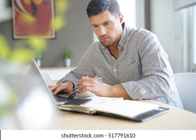 Middle-aged Man Working From Home On Laptop Computer