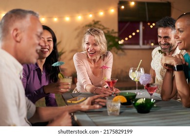 Middle-aged Mature People Having Cocktails Party Together. Group Of Friends Cheering Drink Glasses Celebrating Happy Hour In Bar Restaurant. Old Friendship Enjoying Weekend.