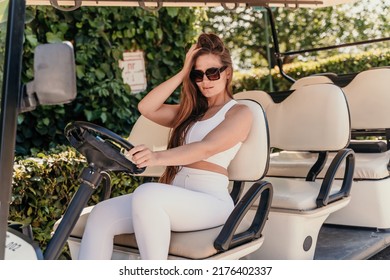 A middle-aged woman is driving a car for transporting tourists. Electric car, Tourist bus. Car for transporting people around the hotel, park, golf club