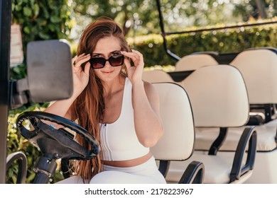 A middle-aged woman is driving a car for transporting tourists. Electric car, Tourist bus. Car for transporting people around the hotel, park, golf club